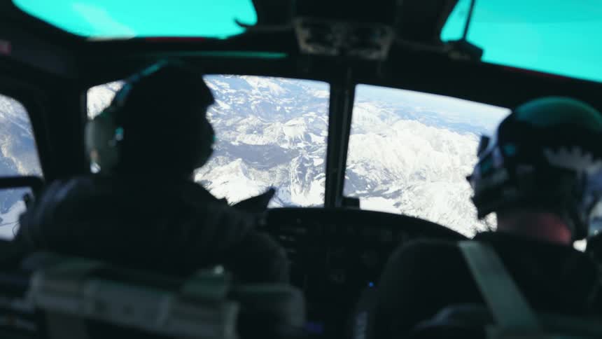A helicopter flies in the clear sky
