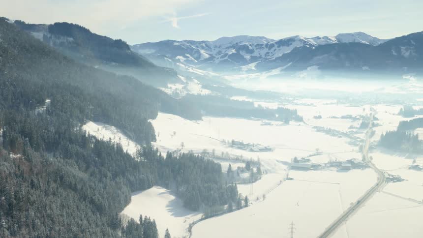 Aerial view of snow covered mountains are displayed