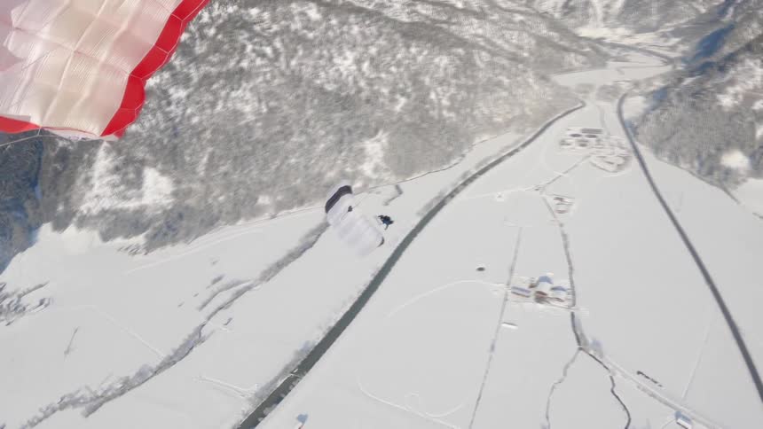A person floating with a parachute while sky diving