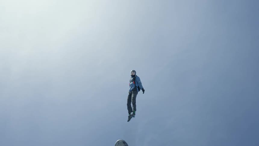 Sky diver jumping out helicopter and gliding through the air