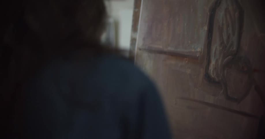 A woman is painting on the canvas