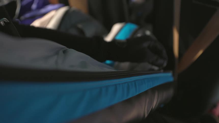 A person zips up their sleeve