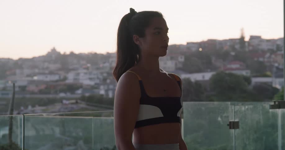 Young fit woman wearing sports clothes working out with dumbbells at home in the morning
