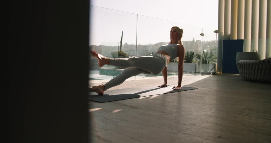 A woman is doing yoga on her terrace