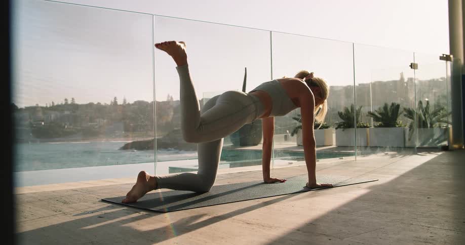 A woman is performing yoga on the terrace