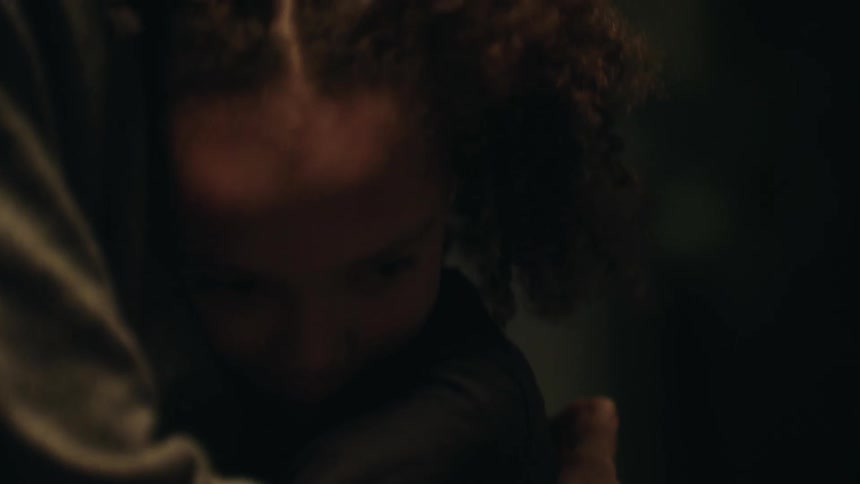A man hugging a little girl in a room with a window in the background