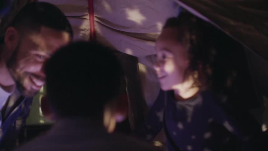 A father and his children camp in a tent at home
