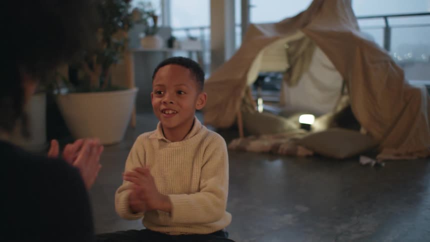 A mother and son playing clapping games