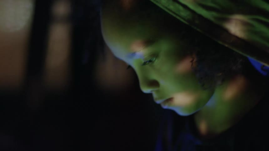 A young girl sitting in the dark