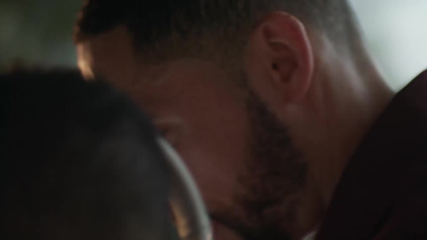 Father helping his son with homework at home
