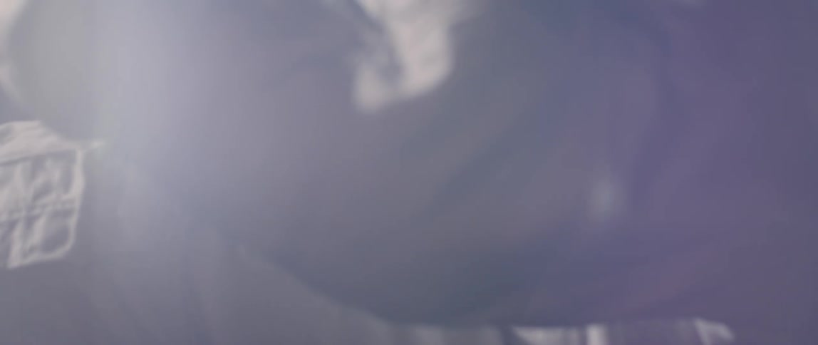 An astronaut is floating in a black area