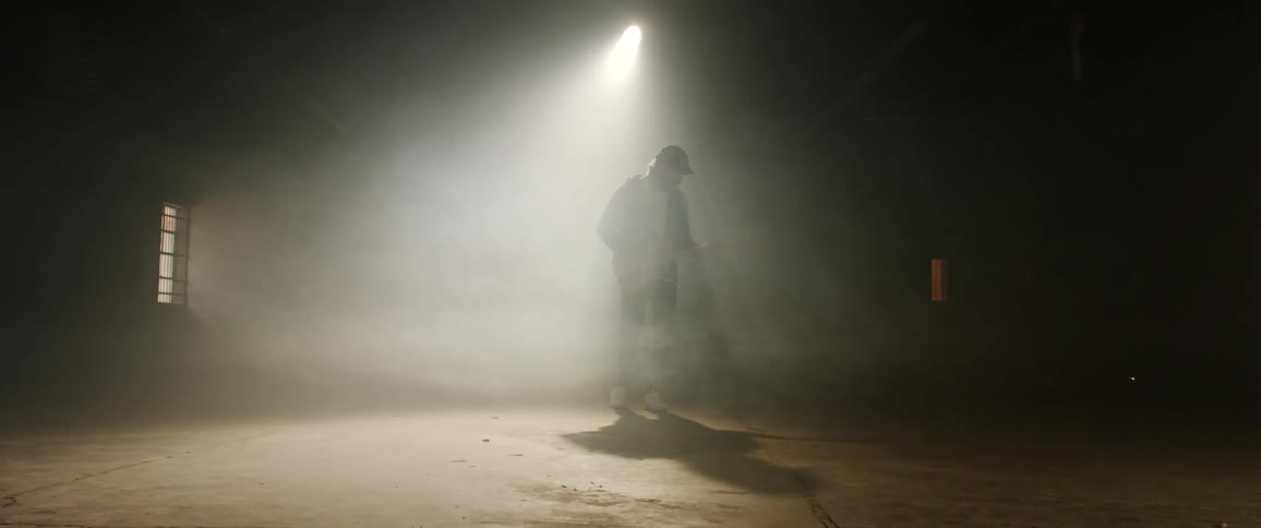 A person is playing guitar in the dark room