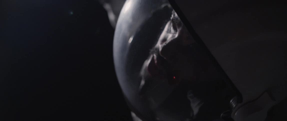 A man wearing a space suit spins slowly