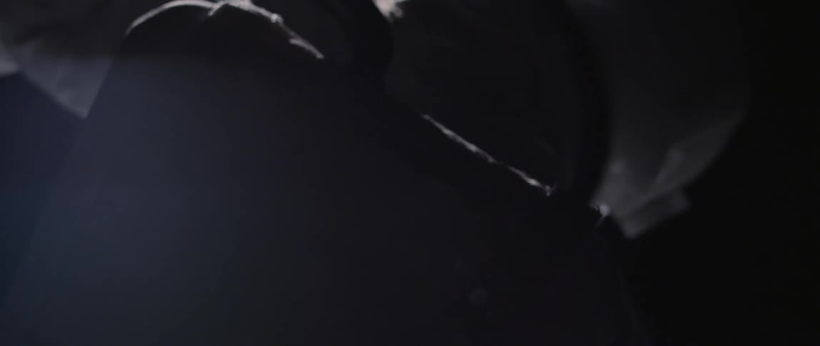 Close up of an astronaut floating in a dark area