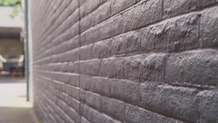 A book is thrown against a brick wall