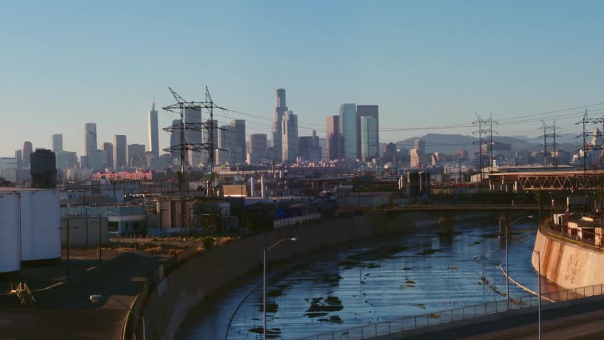 A flood control channel in a metropolis on a clear day