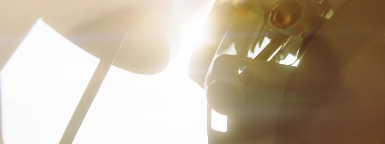 A bright light shining behind metal equipment