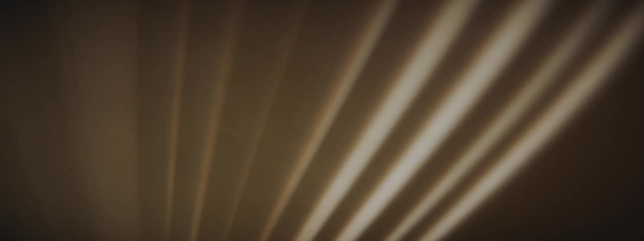A ceiling with light shining and shadows moving