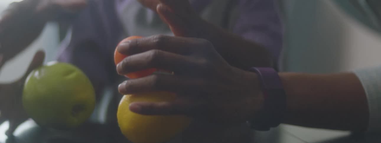 A mother and her child playing with fruit