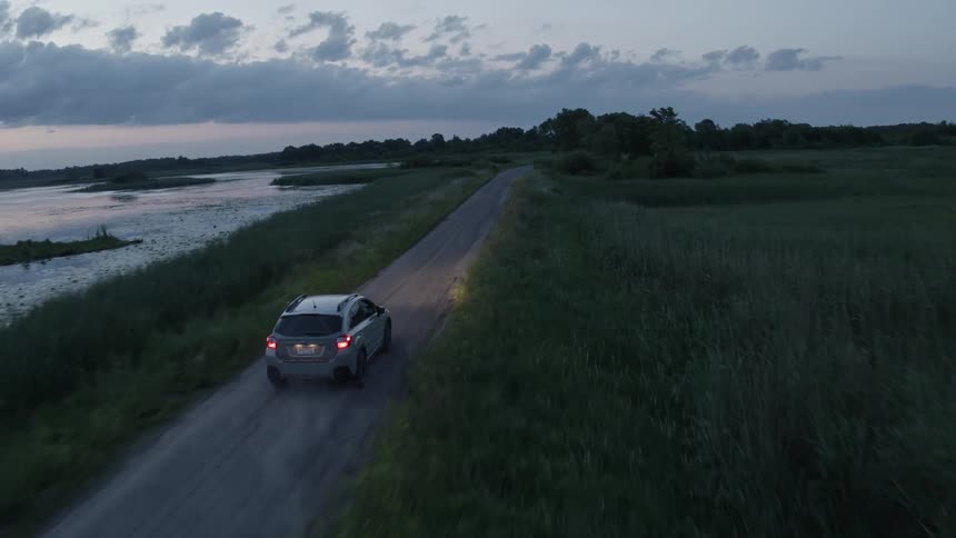 A car is driving in a rural area in spring