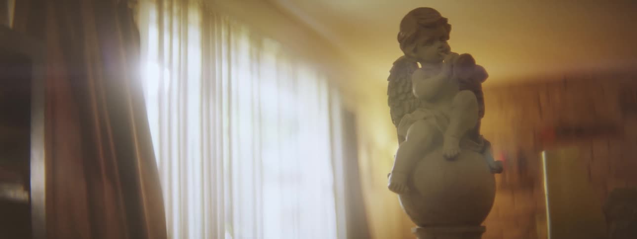 Small figurine of an angel over the table on a living room in a house