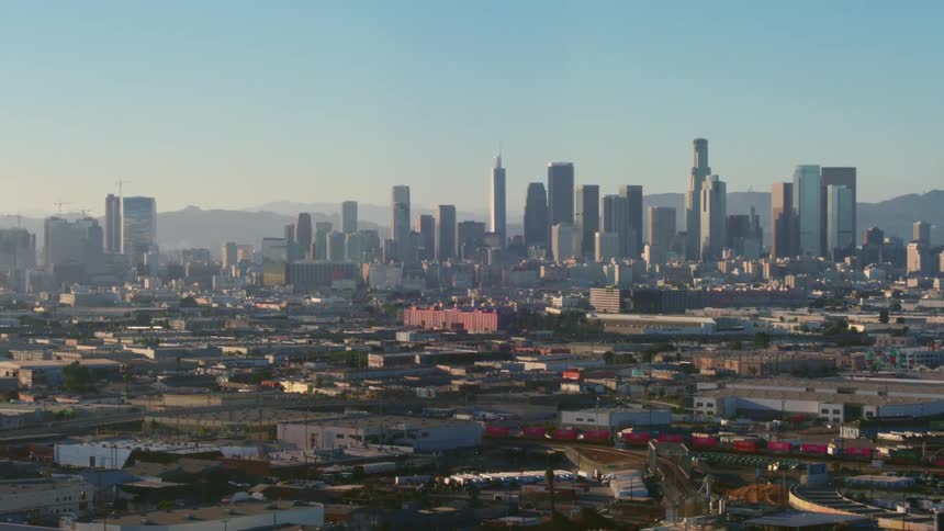 A city skyline with buildings and skyscrapers with the sky and clouds in the background