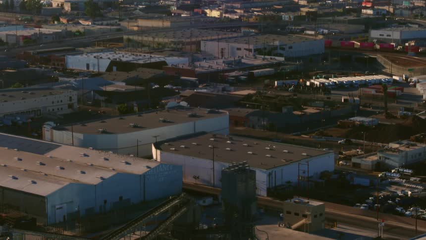 Flying over a city area with buildings in the distance