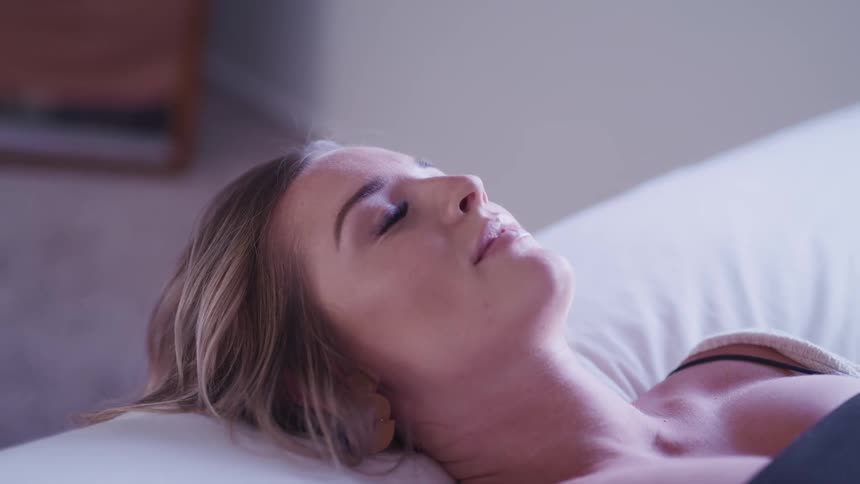 A woman laying on a bed relaxing