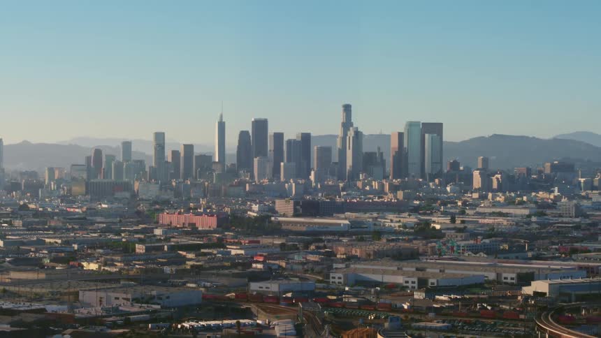 City skyline with many skyscrapers and mountains in the distance