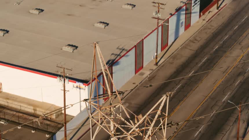 Transmission tower and cables in area with many buildings