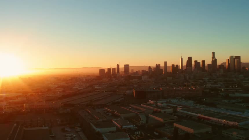 The sun rising over the city skyline