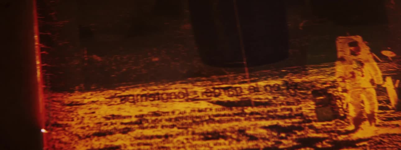 A piece of film showing an astronaut is put on the light