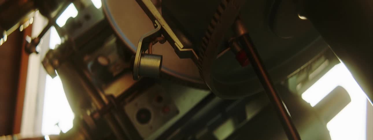 A hand positions a telescope in an observatory