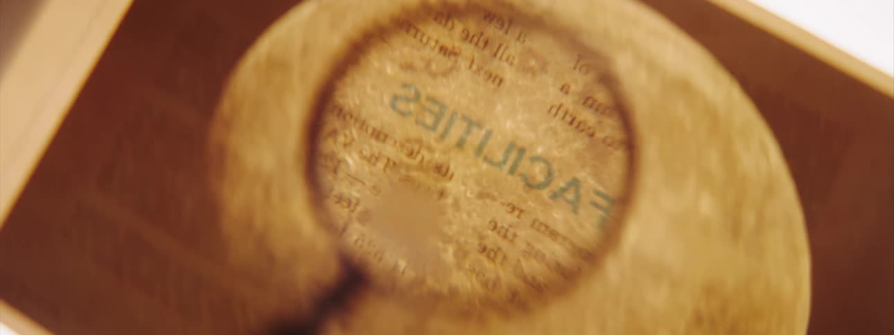 A person is reading something with a magnifying glass