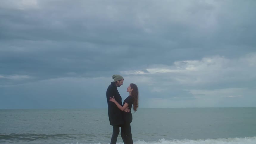Man and woman are hugging at the beach