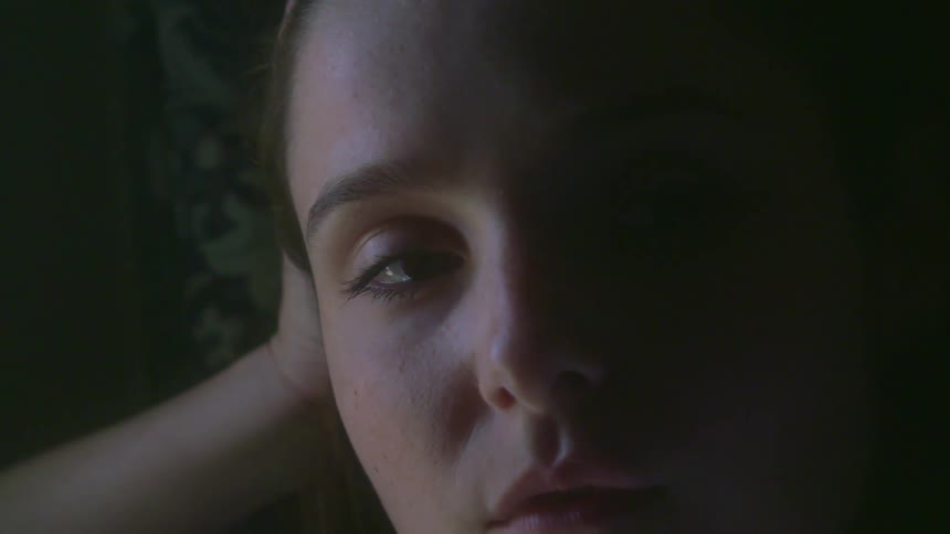 A woman contemplating near soft window light