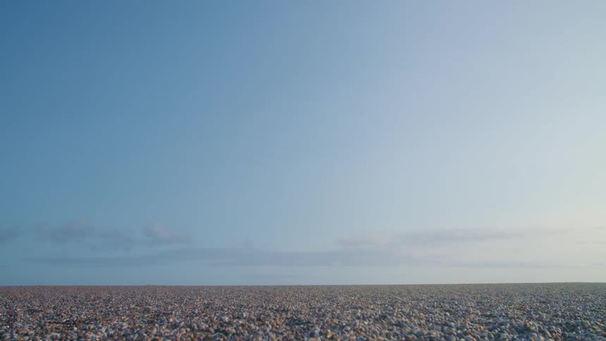 Coastline under hazy blue sky