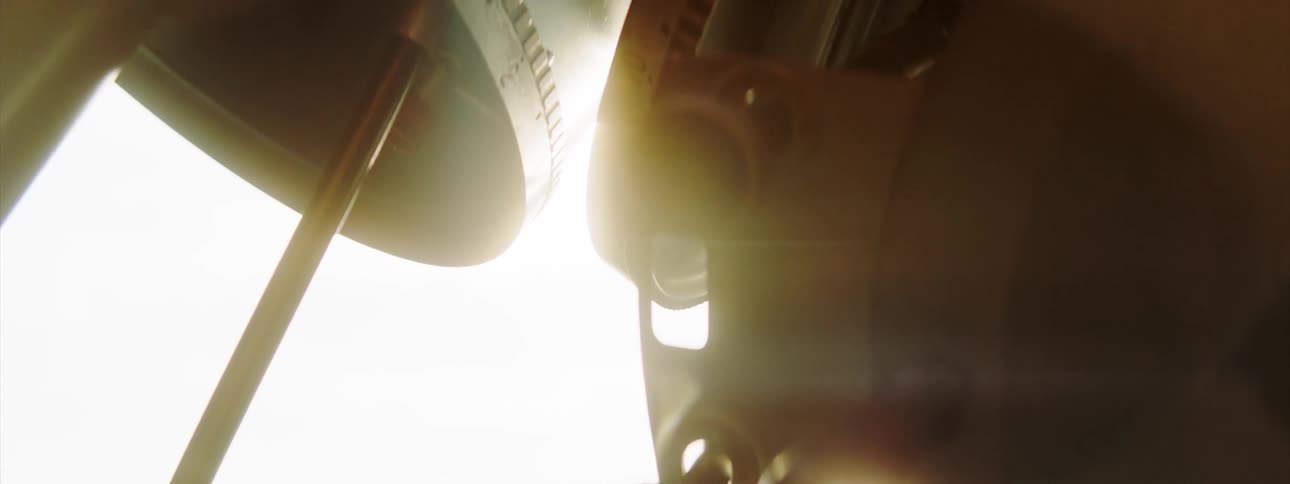 The sun shining down on gears as they turn on machinery