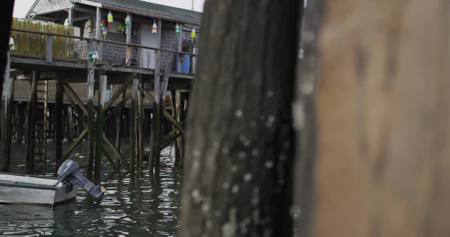 A boat is docked near a tall pier