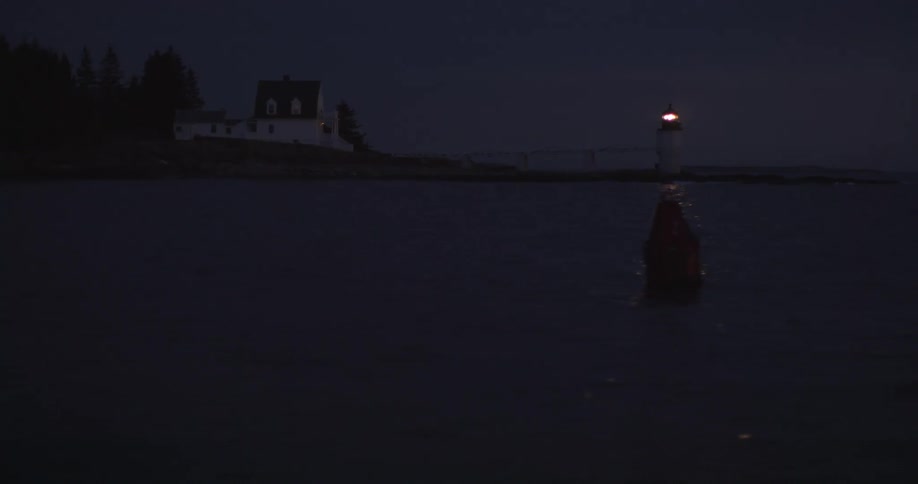 A lighthouse in the distance at night