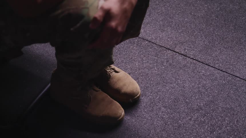 Boots of an american soldier sitting inside a room