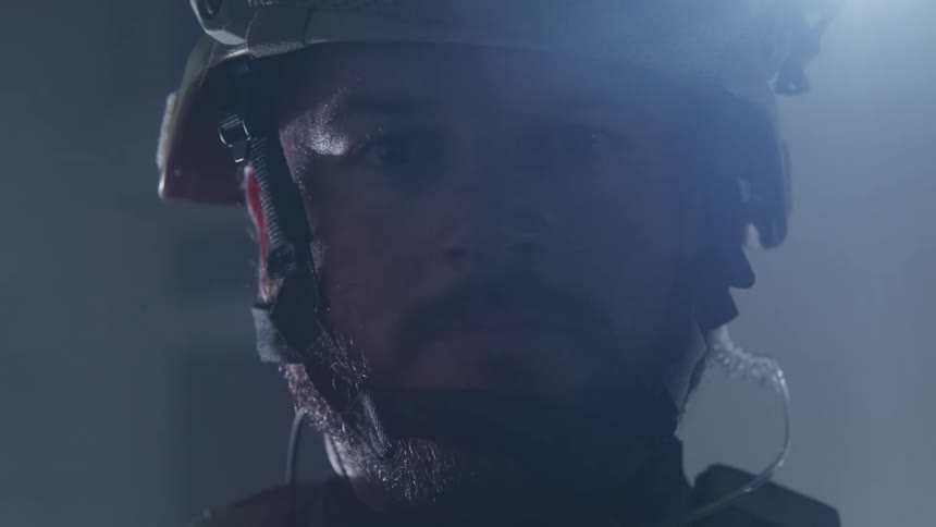 A man is standing and wearing a bicycle helmet