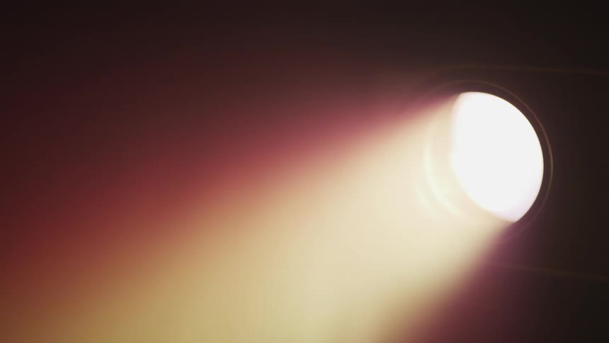A beam of light shining through a hole into darkness
