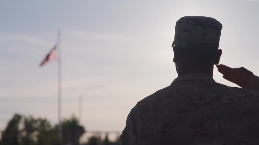 A soldier saluting the american flag