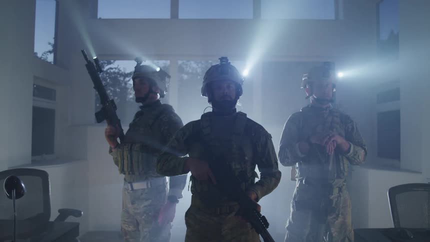Three military members looking around a room