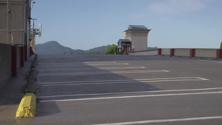 An empty parking lot is displayed during the day in spring