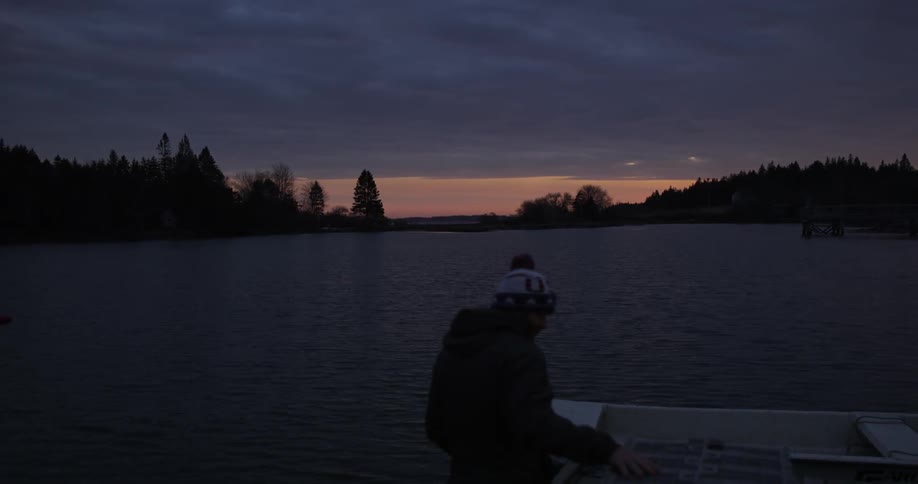 A person walking out on a dock at dusk
