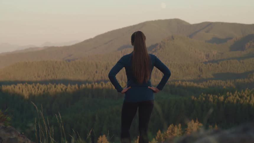 A woman looks out over the fields