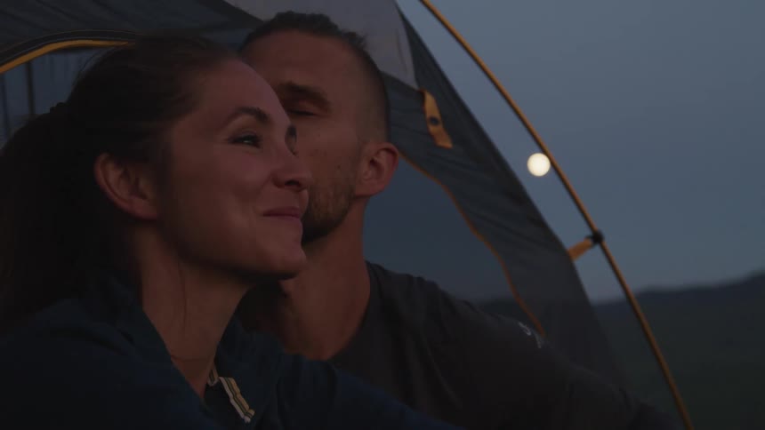 A man kisses a woman on the forehead