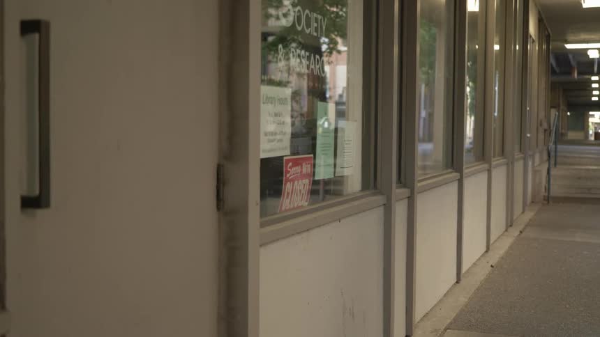 A closed storefront with a red closed sign on the window